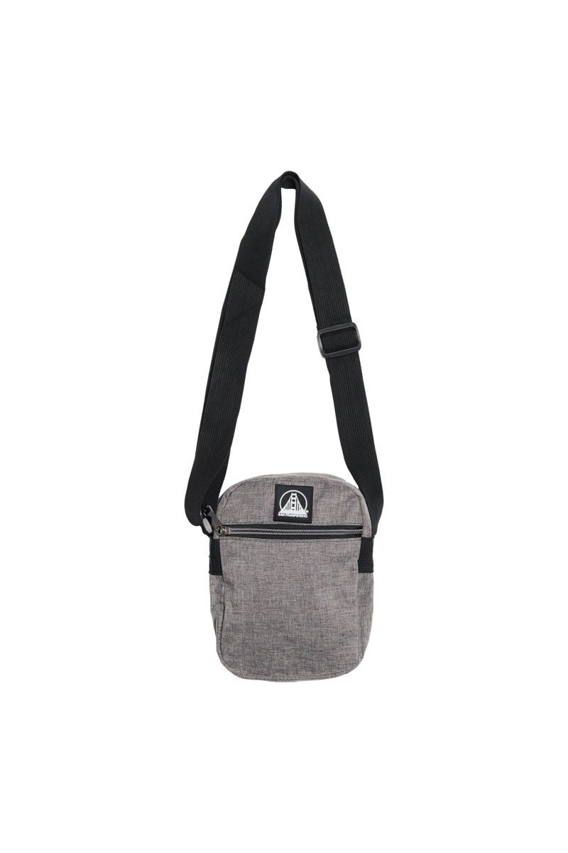 The Small Sling Bag is a gray crossbody with zippered pockets, a black adjustable strap, and a front zipper pocket, displayed on a white background.