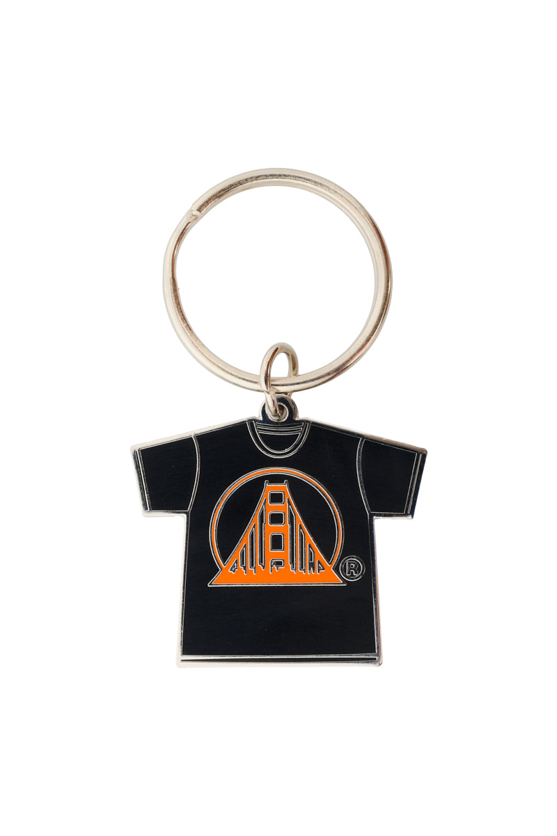 The sleek Logo Tee Keychain features a metal T-shirt-shaped pendant with an orange bridge design and enamel filling, ideal for collectors.