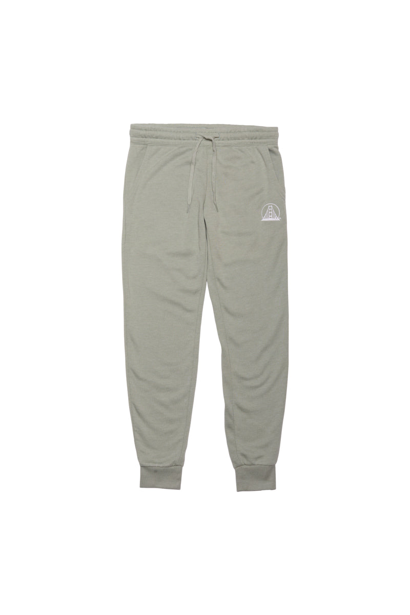 The Womens Embroidered Logo Joggers are light gray, made from a cozy cotton/polyester blend, and feature an elastic waistband with a drawstring and a small white logo on one side.