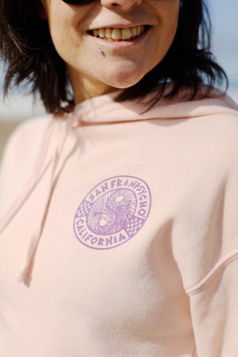 A vibrant smile lights up the face of a person in an 80s-inspired, pink Yin-Yang Crop Hoodie featuring a San Francisco California logo.