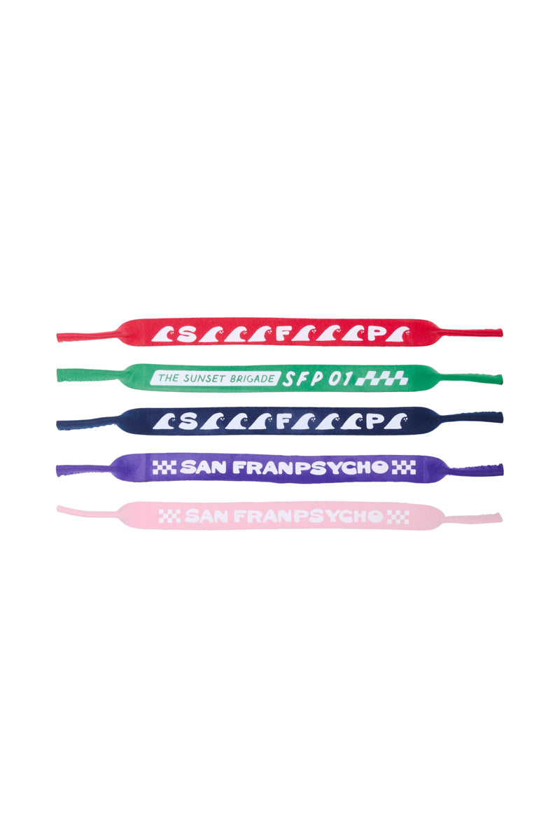 Four colorful Sunglasses Straps with various text designs are displayed on a white background, showcasing a vibrant, 80s-inspired collection by San Franpsycho.