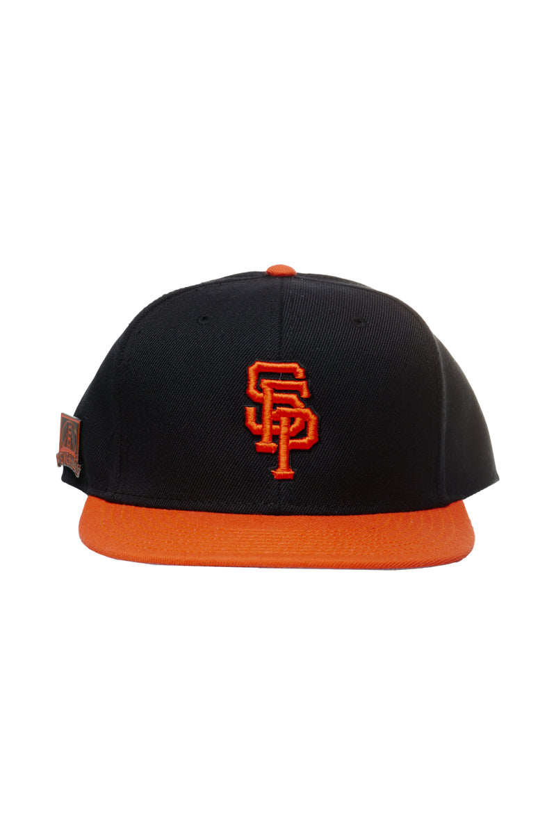 Psychos Logo Snapback w/Pin: A black and orange snapback baseball cap featuring an embroidered SF logo on the front, an orange brim, and an adjustable back for a perfect fit.