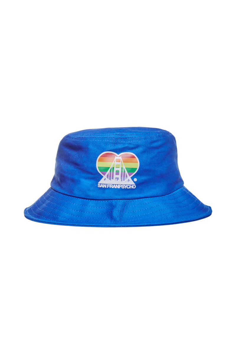 This Rainbow Logo Bucket Hat, featuring a vibrant blue color with a striking rainbow heart and bridge design, is branded with the San Fran Psycho label. Ideal for demonstrating support for the SF LGBT Center, this hat stands out as one of those distinctive rainbow bucket hats that captures attention wherever you wear it.