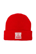 Red Waffle Beanie featuring a natural and red logo patch with a stylized bridge design and the text San Franpsycho.