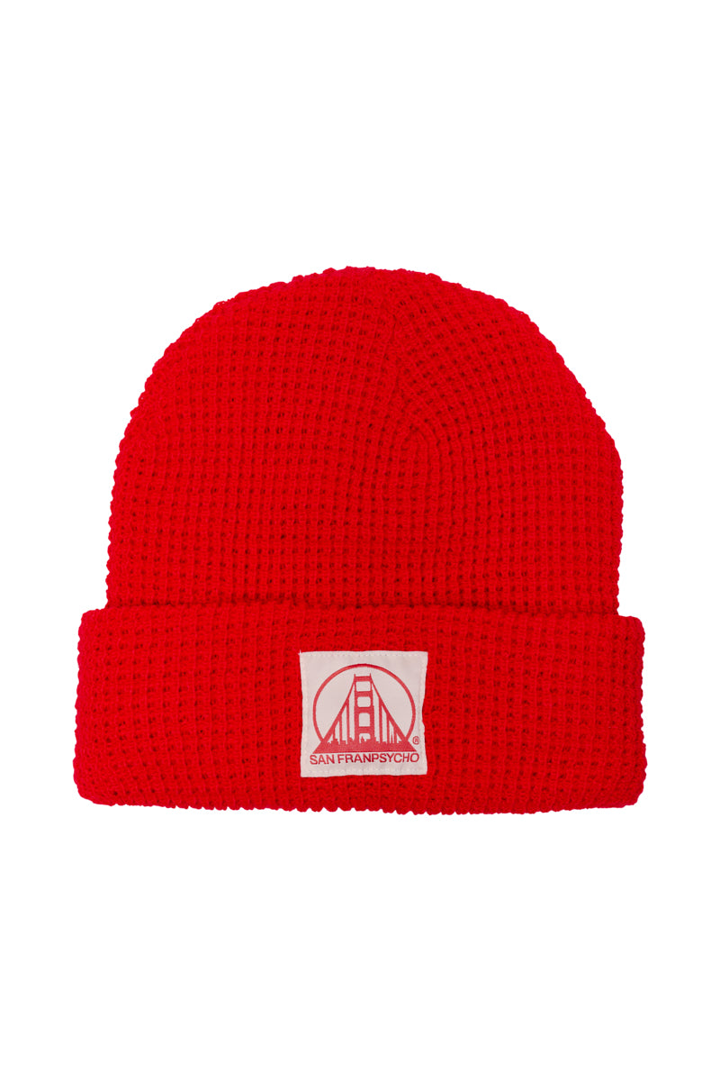 Red Waffle Beanie featuring a natural and red logo patch with a stylized bridge design and the text San Franpsycho.