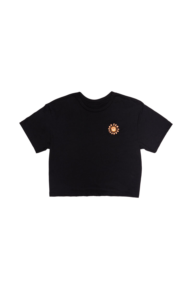 This women's fashion piece, the Sunny Crop Top, is a black embroidered crop top showcasing delicate circular floral embroidery reminiscent of Ferris Plock artwork.