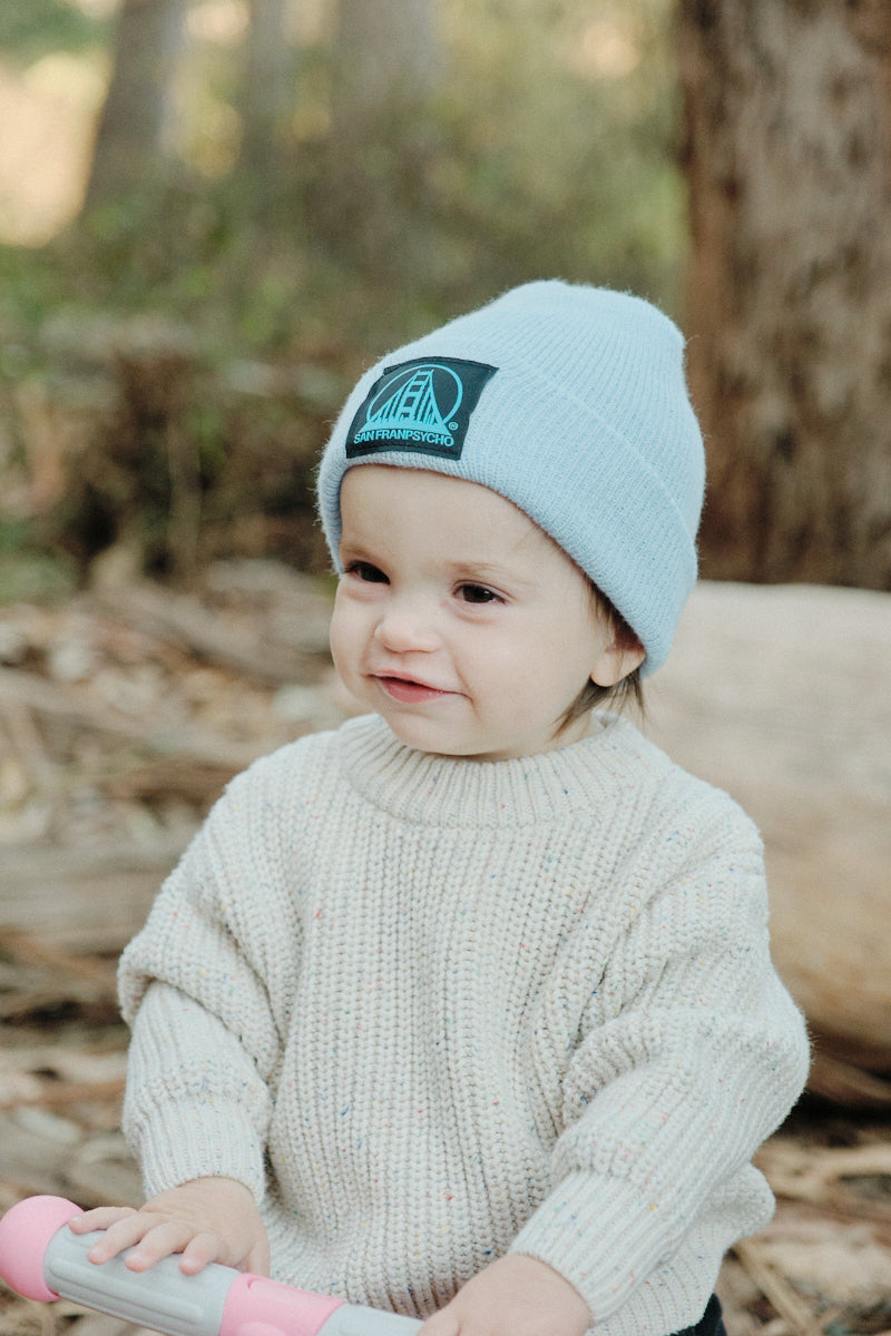 toddler wearing Light Blue Baby Beanie w/Black/Blue Logo
