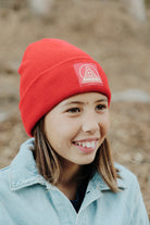 girl wearing Red Kids Beanie w/ Red/Gold Logo Patch