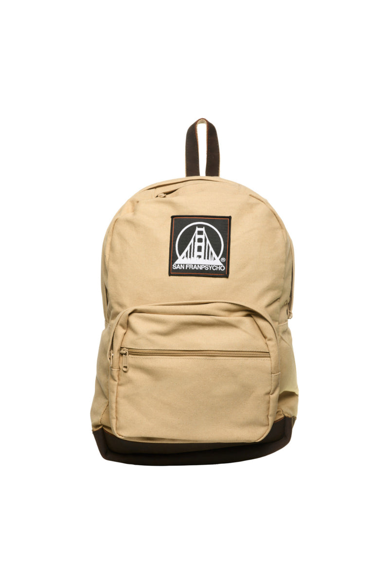 Khaki backpack with durable canvas and leather trims, featuring a bridge design patch in black and white on the front pocket.