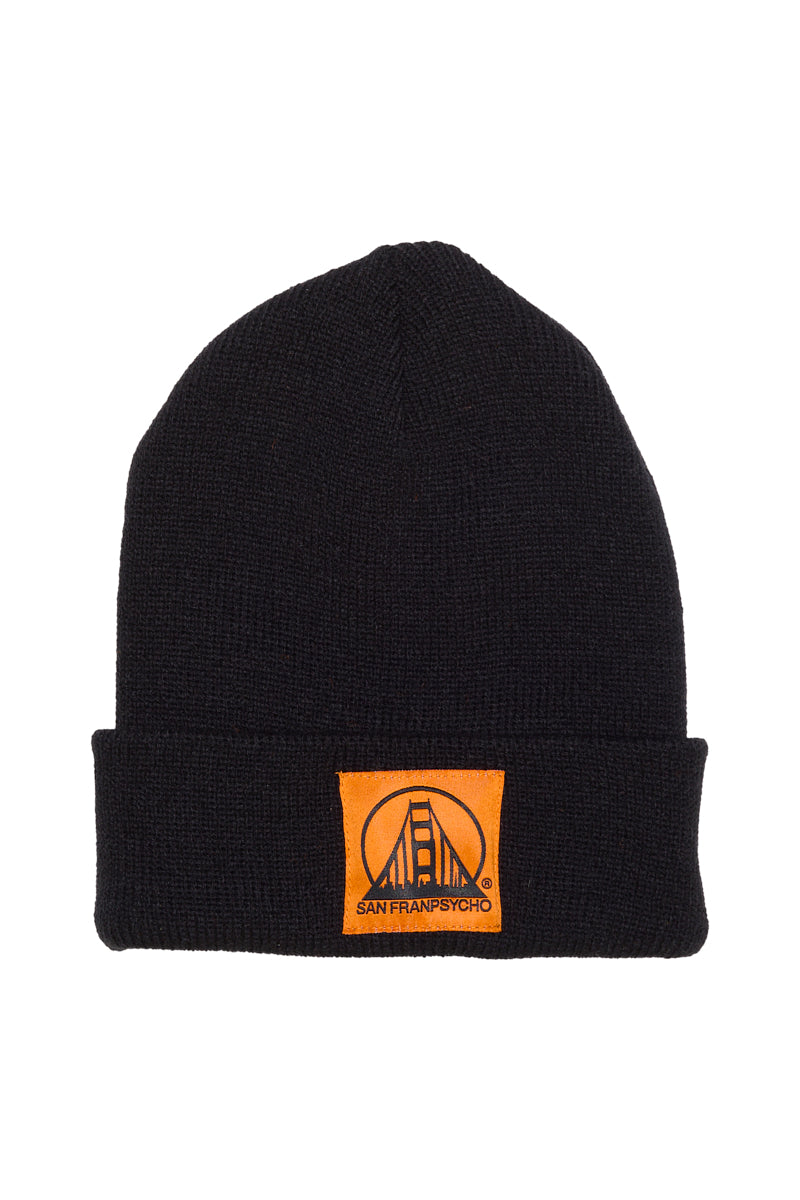 The Black Kids Beanie w/ Orange/Black Patch features a front cuff patch with a bridge and San Franpsycho text—stylish and warm for kids.
