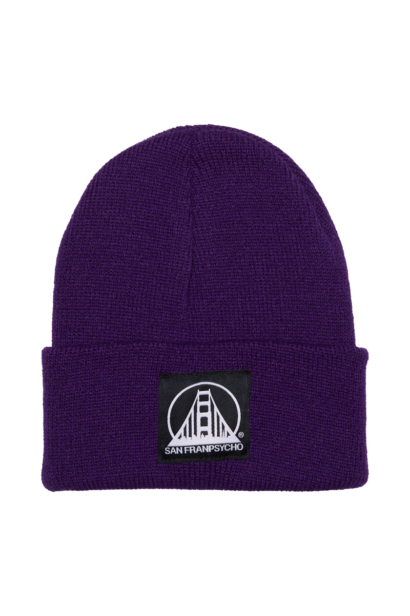 The Purple Kids Beanie w/ Black/White Logo is warm and cozy, featuring a folded brim and a San Franpsycho bridge patch—perfect for kids who want a stylish beanie.