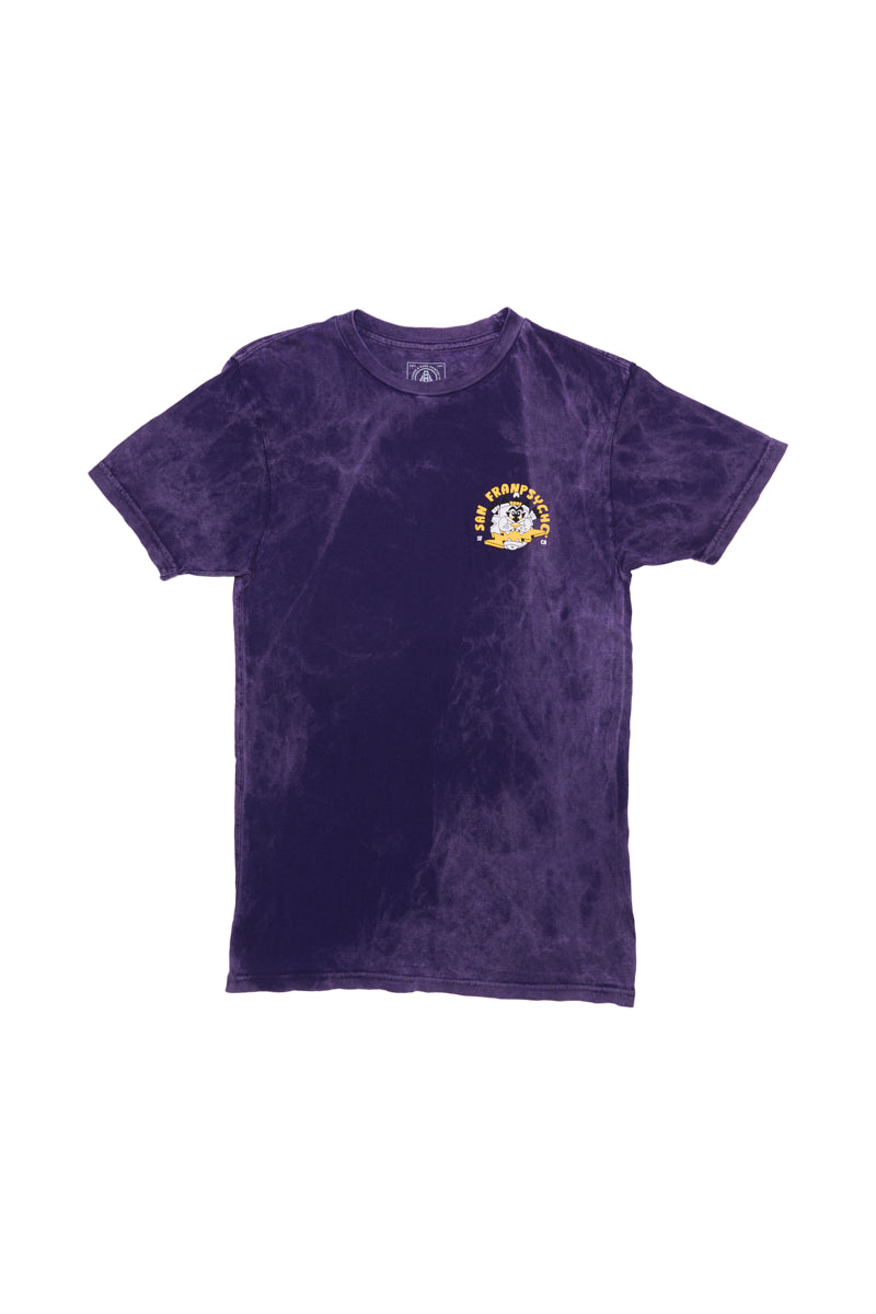 The Surf Trip Tee - Purple is a unisex shirt with a purple tie-dye design and features a small white and yellow logo on the chest, inspired by Ferris Plock artwork.