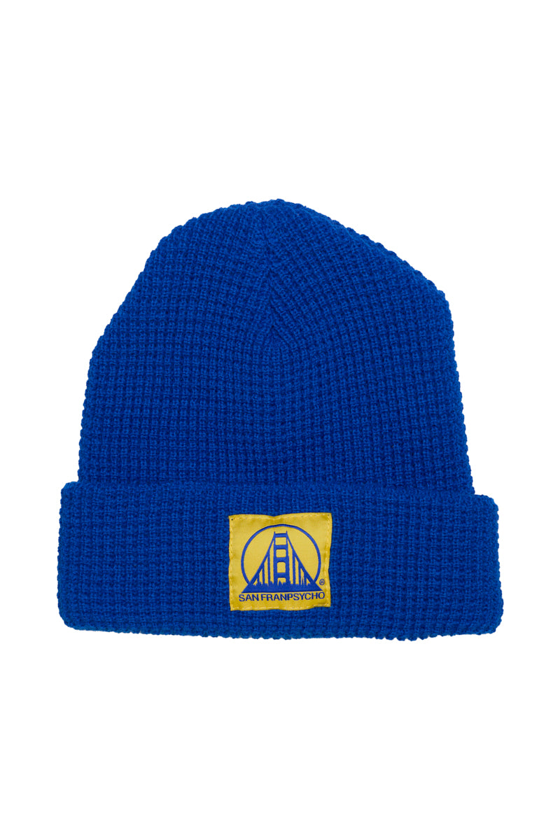 The Royal Blue Waffle Beanie w/ Yellow/Blue Logo showcases a bridge graphic patch and is crafted for exceptional softness—making it the most comfortable beanie youll wear.