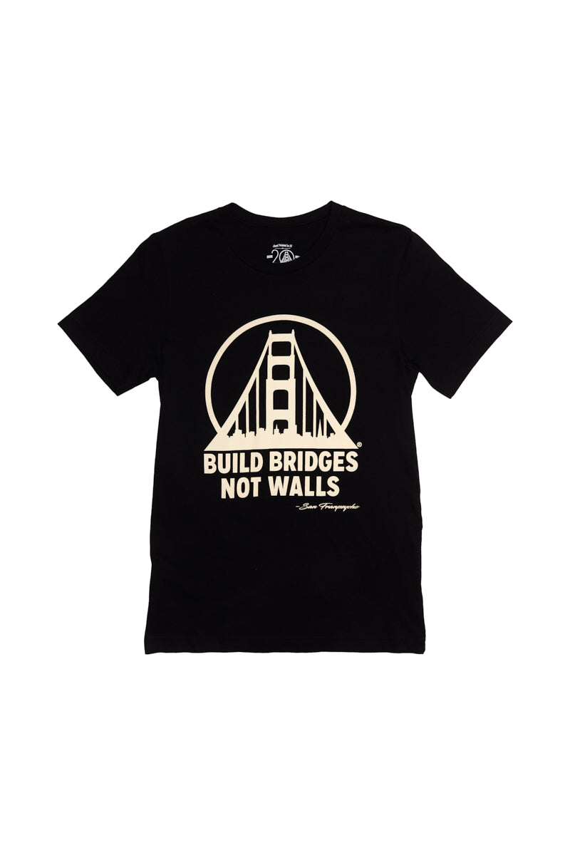 The Build Bridges Not Walls Tee is a black, 100% cotton shirt featuring a bold bridge graphic and the inspiring Build Bridges Not Walls text on the front.