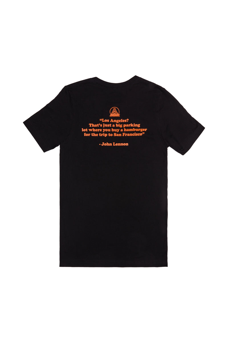The Beat LA Black & Orange Tee features orange text and a John Lennon quote about Los Angeles and San Francisco—a must-have Beatles shirt for any Bay Area fan.