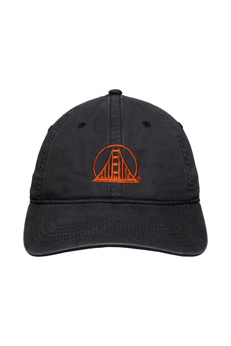 The Rust Logo Dad Hat showcases a faded black design with an orange Golden Gate Bridge logo embroidered on the front, blending classic style and distinctive Bay Area character.