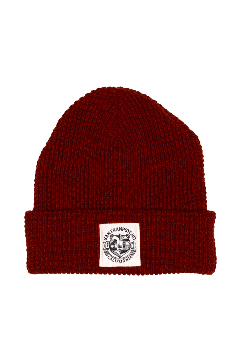 The Bear Essentials Rust Beanie features a white San Francisco California patch on its folded brim—delivering classic West Coast style.