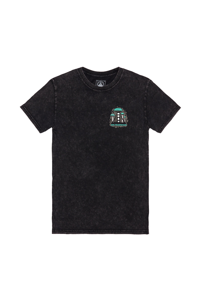 The Mind Bloom Tee is a black mineral wash shirt with a small, colorful skull and mushroom graphic on the left chest, inspired by Erik Abel’s artwork.