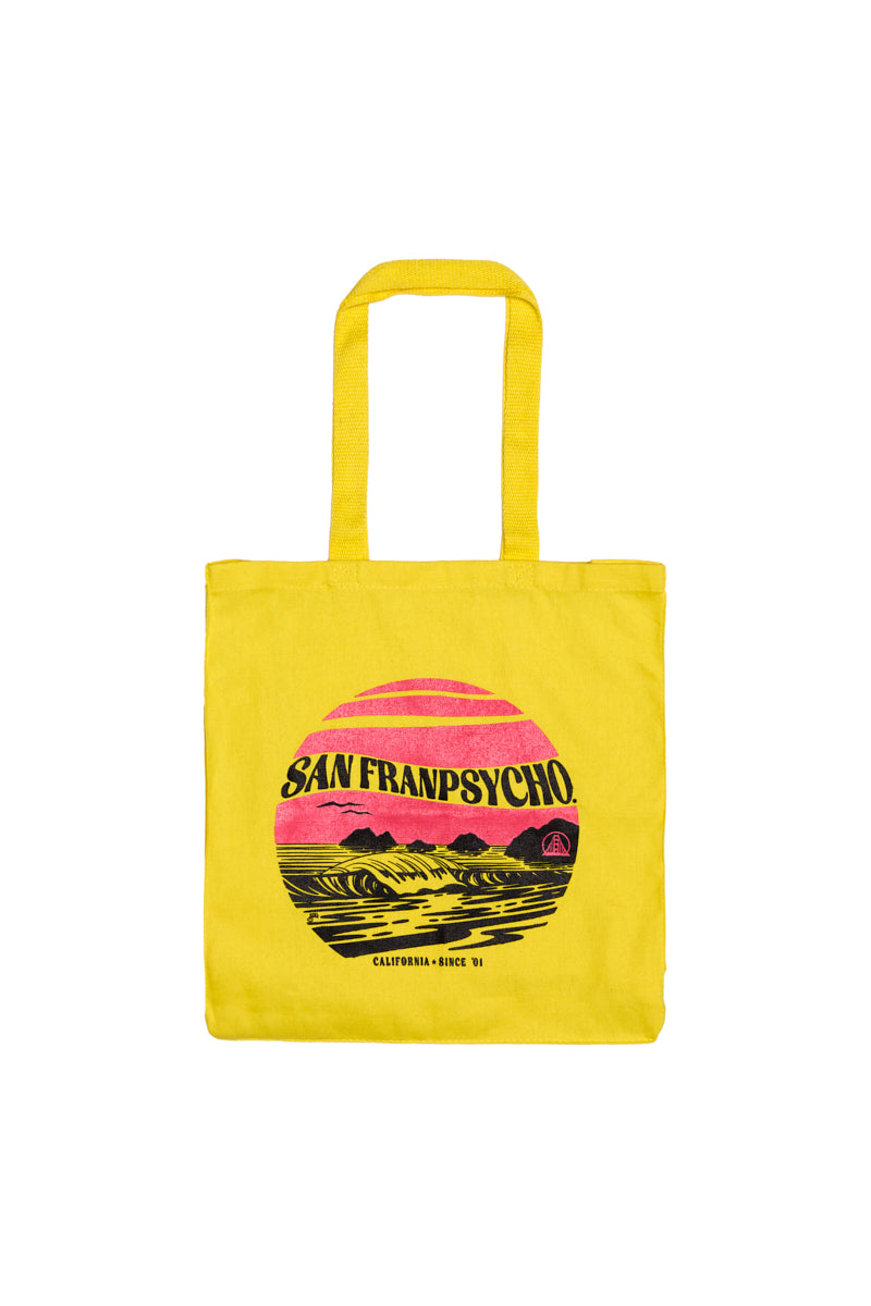 The Kelly's Cove Tote is a bright yellow canvas bag with SAN FRANPSYCHO and a colorful sunset graphic inspired by San Francisco’s vibrant vibes.