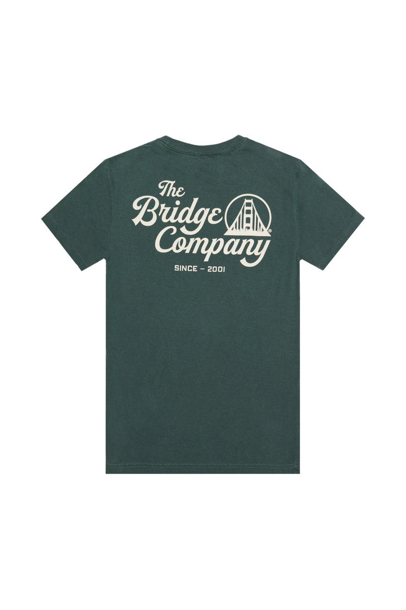 The Bridge Co Tee is a forest green heavyweight cotton shirt with "The Bridge Company," a bridge graphic, and "Since 2001" hand printed on the back.