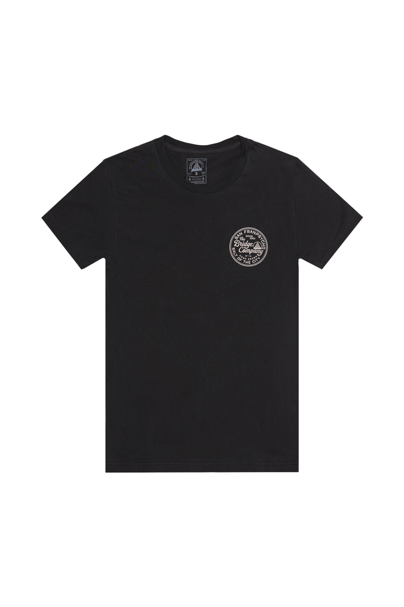 The Salt of the City Tee is a black heavyweight cotton short-sleeve shirt featuring a small white circular graphic on the left chest, hand printed in San Francisco.