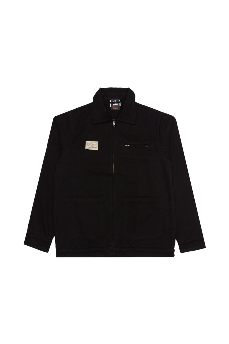 Bridge Co. Chore Jacket—black zip-up workwear with a collar, chest label, and front pockets, laid flat on a white background; a timeless piece made in San Francisco.
