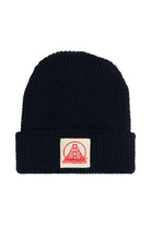 A navy acrylic waffle beanie featuring a patch with a natural and poppy San Francisco logo on the front, showcasing classic San Franpsycho style.