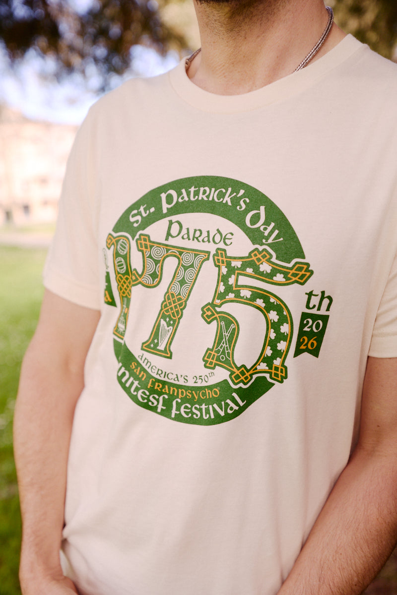A man stands outdoors wearing the 175th St Patrick's Day Parade Tee, a limited edition shirt made for the San Francisco Irish Festival.