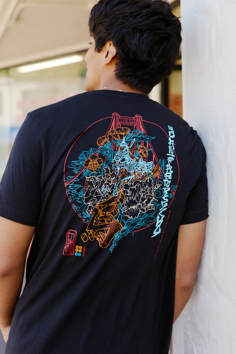 A man wears the Year of the Horse Tee, featuring a vibrant graphic on the back, standing outdoors—an ideal choice for celebrating Lunar New Year in style.