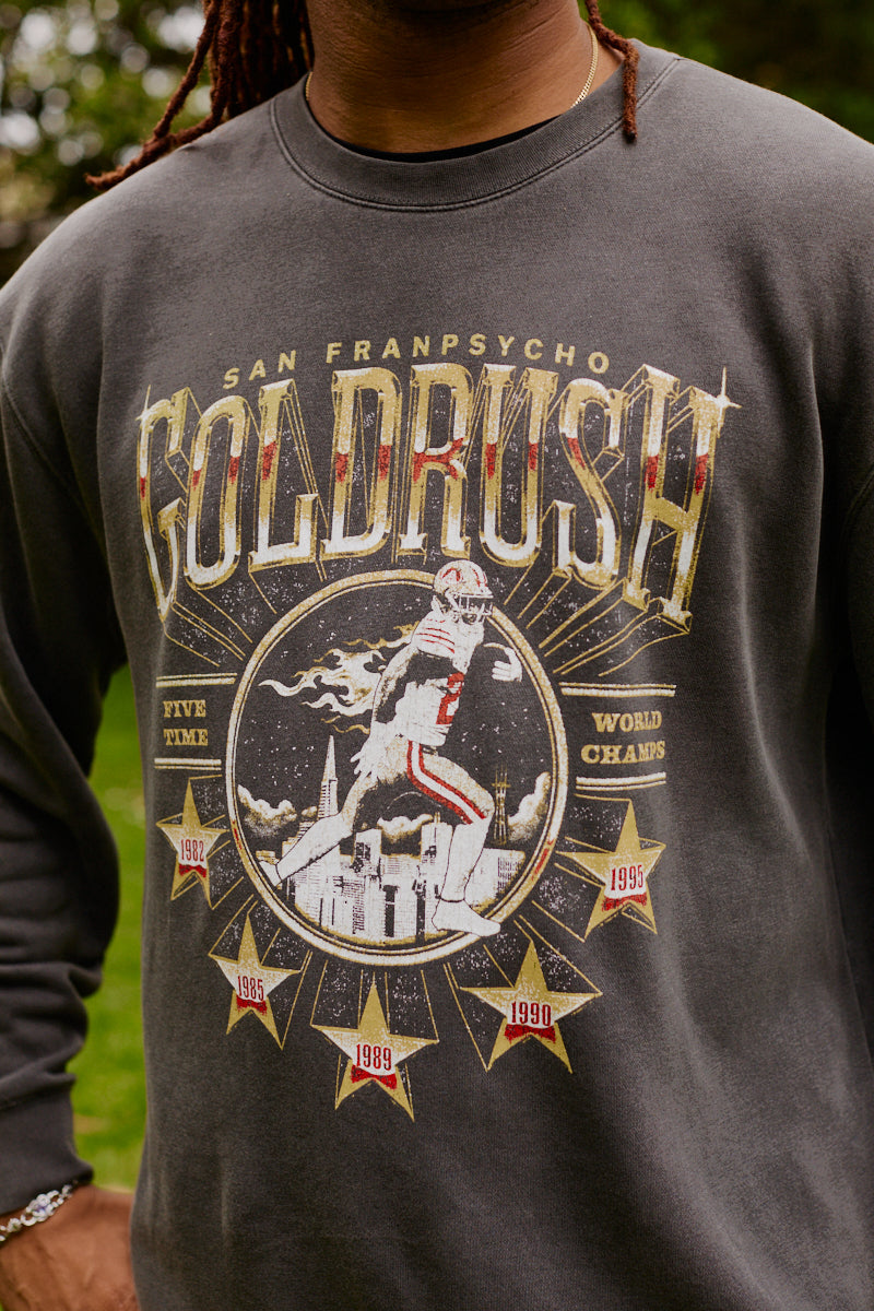 Person wearing the Gold Rush Crewneck featuring a dark 49ers design with a football graphic and championship years, perfect for San Francisco fans.