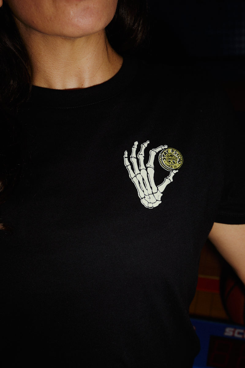 Black Women’s Quarter Cent Tee crop top featuring a graphic of a skeleton hand holding a yellow coin.