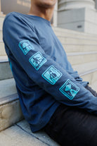 Blue 3D Logo Long Sleeve featuring cyan graphics of a mushroom, surfer, bottle, and UFO.