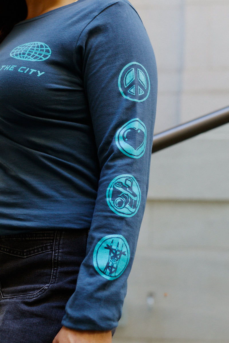 Dark blue 3D Logo Long Sleeve featuring a retro-futurism globe graphic and circular icons on the sleeve.