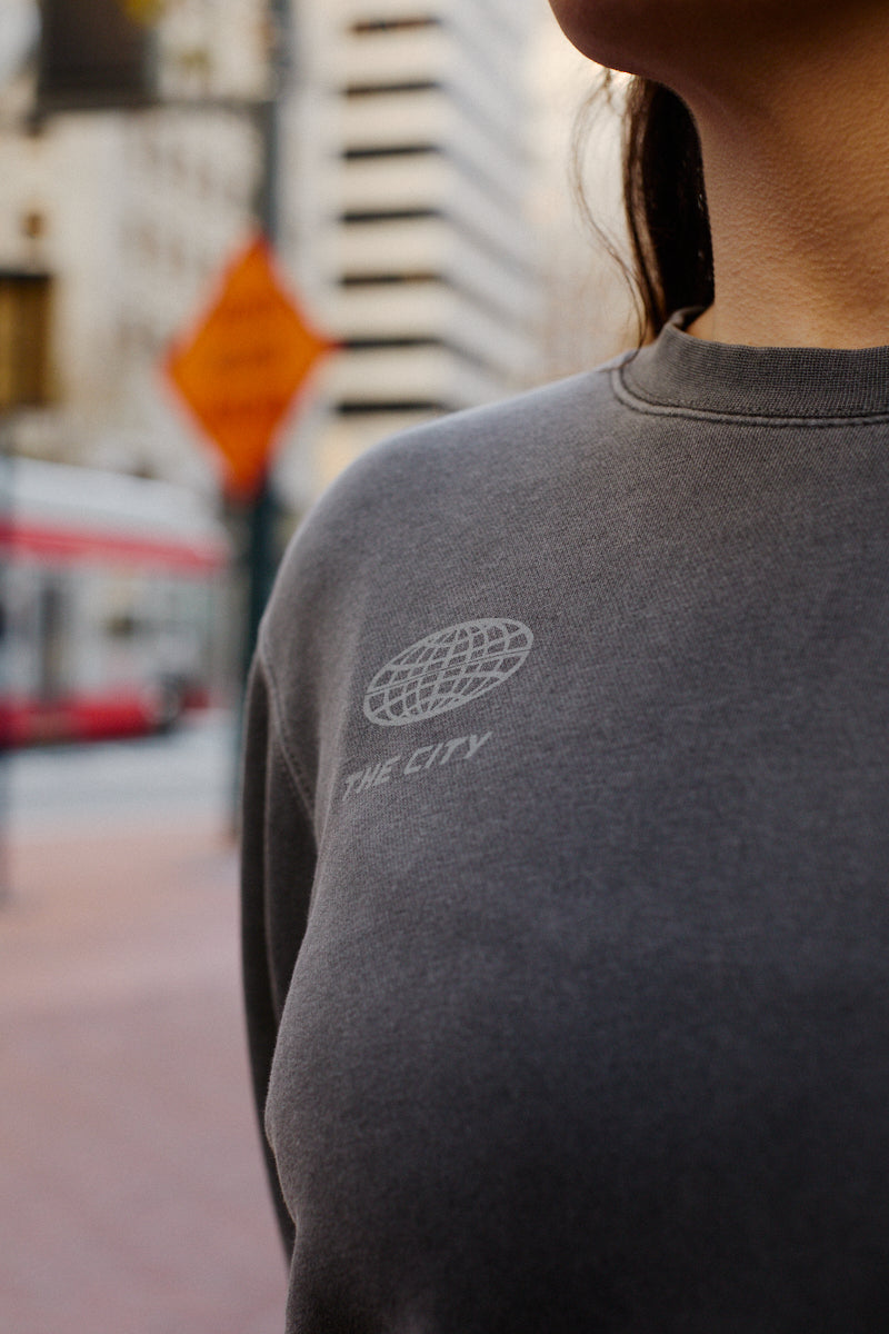 Gray 3D Logo Crewneck featuring a globe graphic and the words THE CITY printed on the chest.