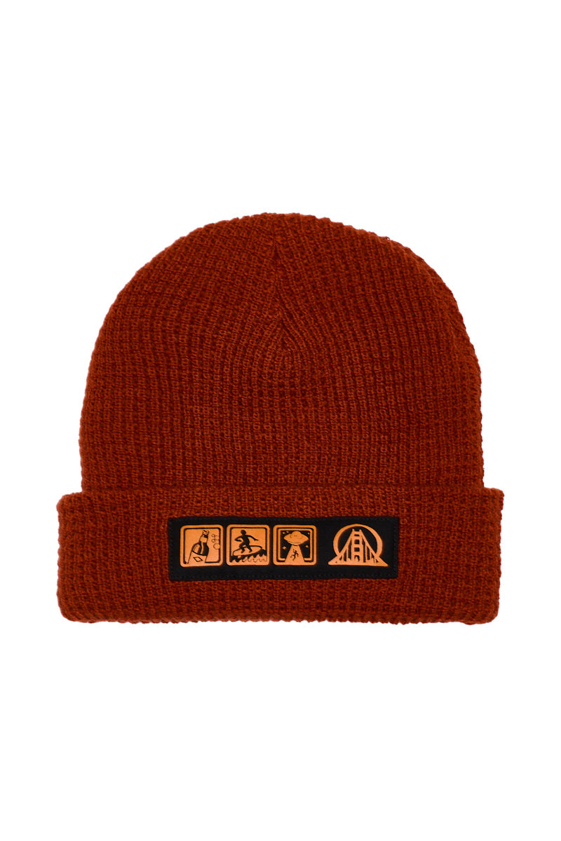 Icons Beanie in rust-colored ribbed knit with a patch featuring four orange surf and alien icons.