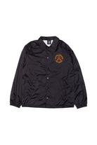 The Dirty UFO Coaches Jacket features black snap buttons and a yellow-red graphic on the left chest, shown flat on a white background. This jacket is part of the exclusive SFP x Dirtybird collaboration.