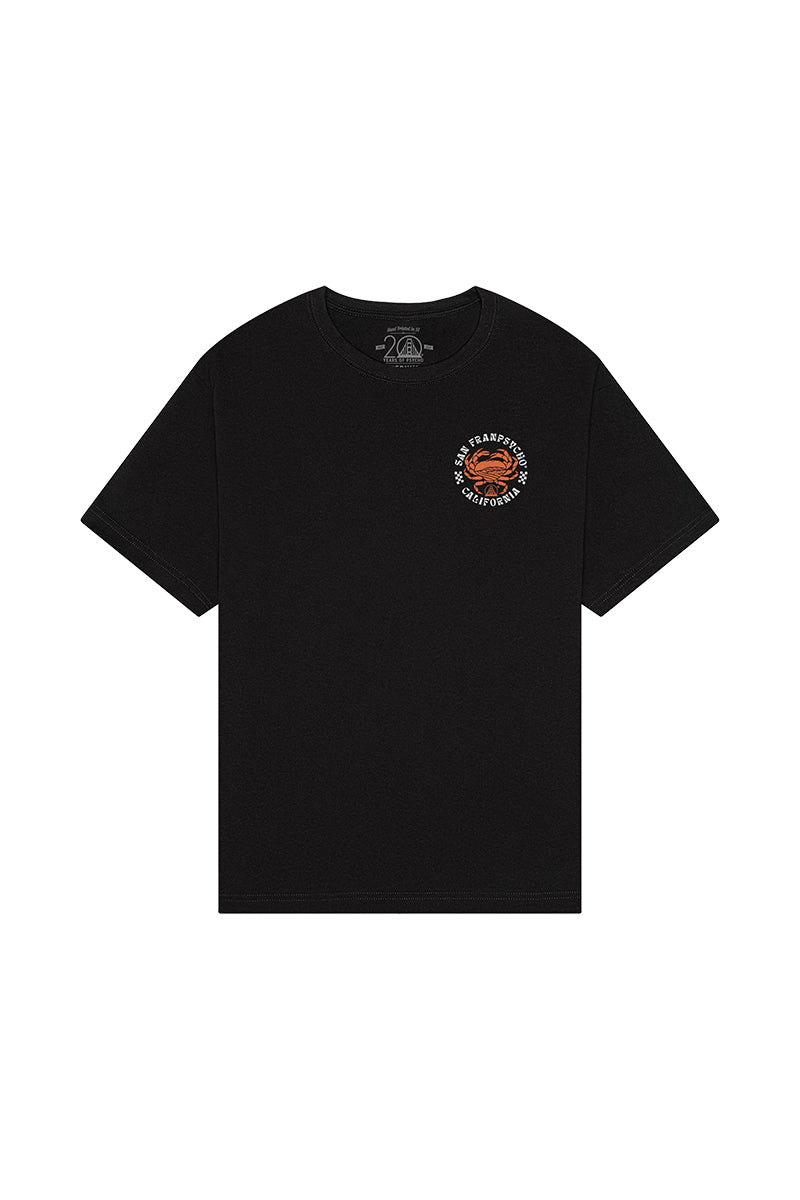 The Wharf Crab Tee is a black T-shirt featuring a small orange and white logo on the upper left front, inspired by San Francisco’s Fisherman’s Wharf vibe.