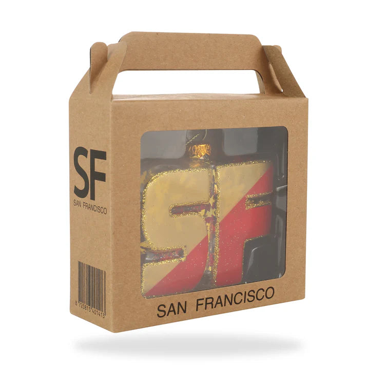 The Xmas Ornaments - Local Elves collection includes a boxed ornament showcasing the letters SF in gold and red, presented in a cardboard package labeled San Francisco. 