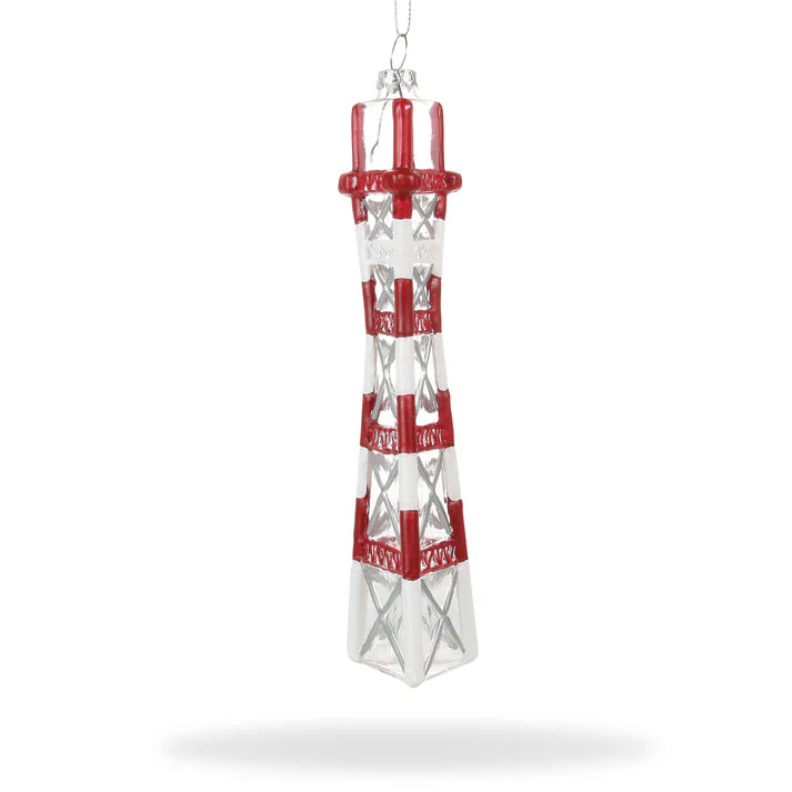 This "Xmas Ornaments - Local Elves" piece is a locally inspired glass lighthouse ornament, showcasing red and clear sections. It hangs elegantly from a thin string, capturing the charm of hand-painted glass ornaments reminiscent of Sutro Tower's iconic design.