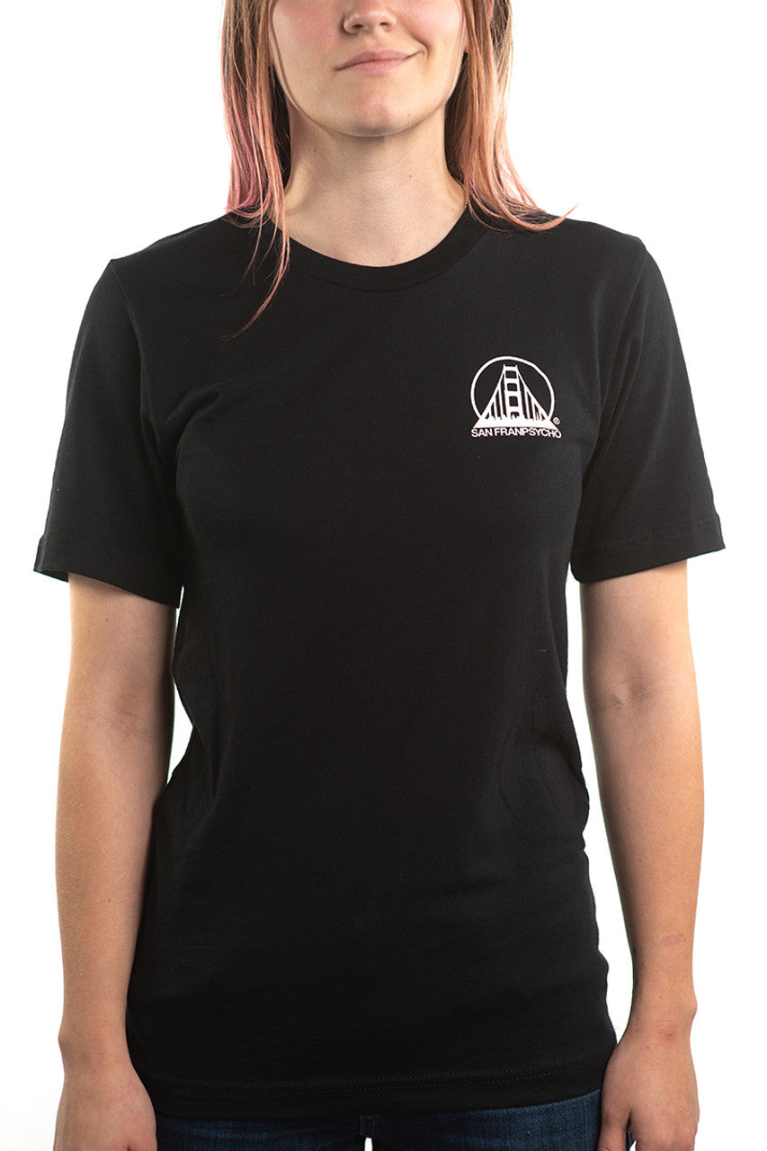 The individual is wearing a Black & Orange Street Skull Tee, made from soft Airlume cotton. The black T-shirt showcases a hand-printed white logo design on the upper left side.