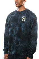 The individual wears the ultra-soft black tie-dye Surf Club Crewneck, showcasing the San Francisco Brew Club logo on the front and blending comfort with style in its distinct design.
