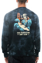 A person wearing the Surf Club Crewneck showcases a skeleton surfing graphic and bold "San Franpsycho Surf Club" text, all in super soft tie-dye.