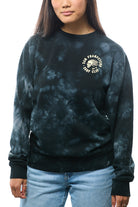 Person wearing a super-soft black tie-dye Surf Club Crewneck with a San Francisco logo, paired effortlessly with blue jeans.