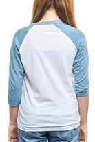 A person is seen from the back, wearing a Youth Seal Logo Baseball Tee in blue and white, made of 100% cotton, with three-quarter sleeves.