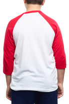 A person viewed from behind is wearing a Youth Ocean Club Baseball Tee, a classic white and red design crafted from 100% cotton for ultimate comfort and style.