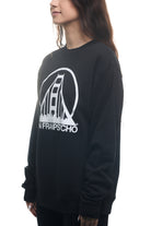 A woman wears the Black & White Logo Crewneck, featuring a classic style in black with a stylized bridge print, the SFP logo, and the text "San Francisco." This sweatshirt is available in various sizes and combines comfort with iconic flair.