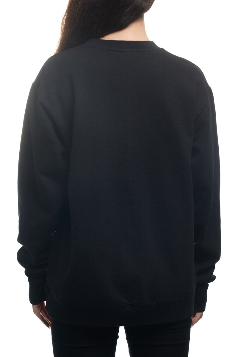 Back view of a person wearing the Black & White Logo Crewneck sweatshirt paired with black pants, facing away from the camera.