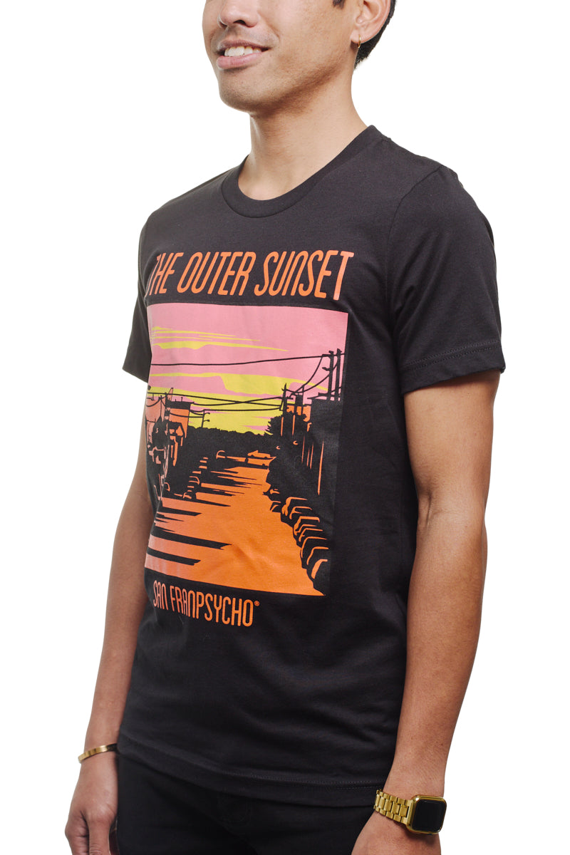 A man wears the Outer Sunset Tee, featuring vibrant sunset graphics and the phrase "The Outer Sunset, San Franpsycho," embodying the relaxed vibe of San Francisco.