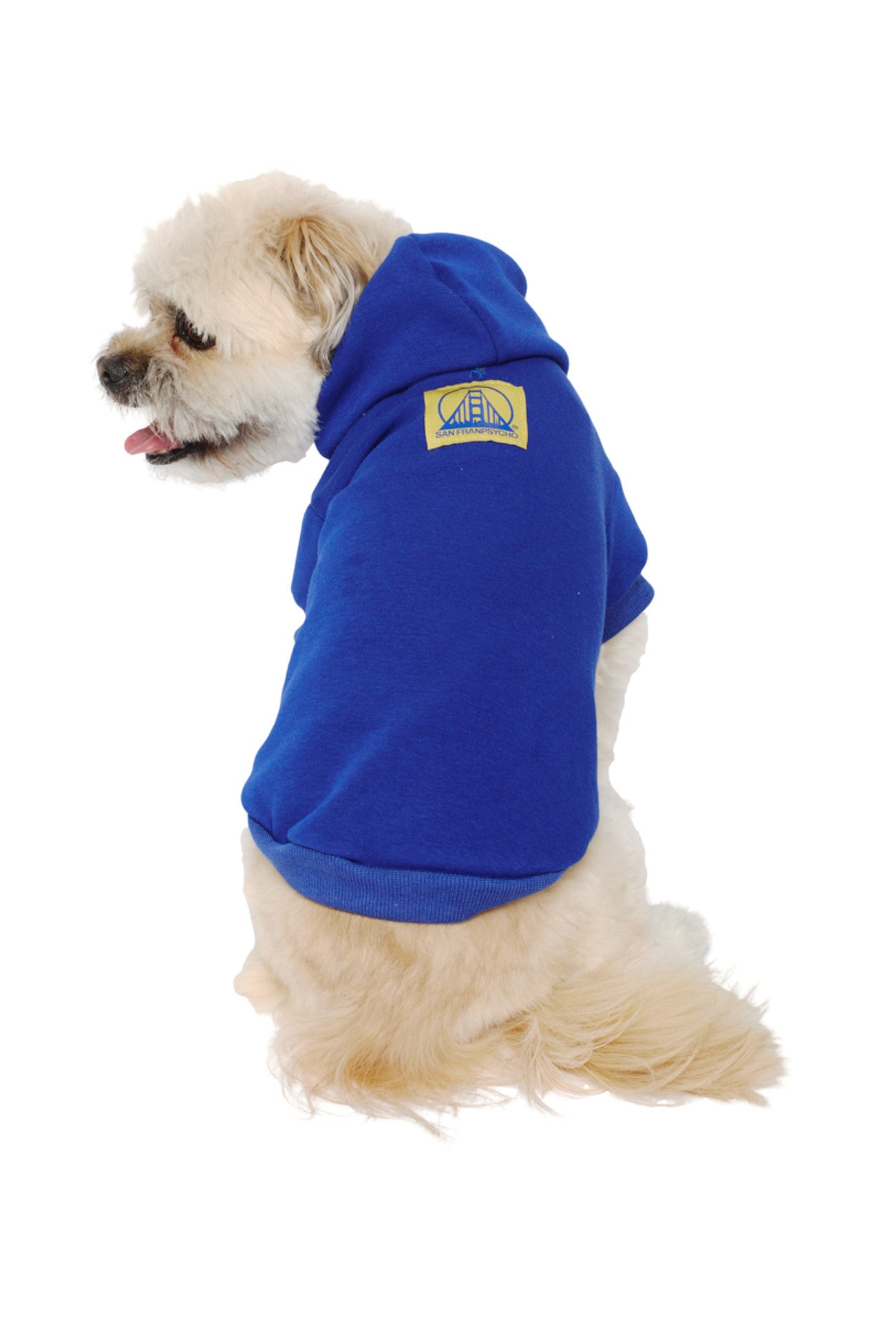 A fluffy white dog sits facing away in the Blue Dog Hoodie w/Yellow/Blue Logo Patch, offering warm comfort for those chilly days.