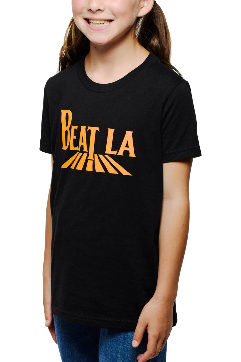Smiling girl wearing a Youth Beat LA Tee - Black & Orange and blue jeans, showing off her Bay Area sports pride.